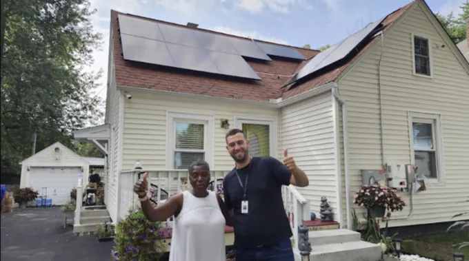 Team Sunshine customer Rita Carter with her completed solar installation
